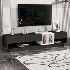 a black and white photo of a living room with a large television on the wall