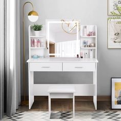 a white dressing table with a mirror and stool