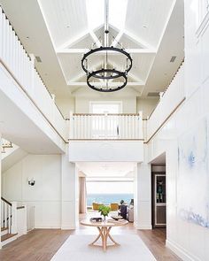 a large open floor plan with white walls and wood floors on the other side of the room