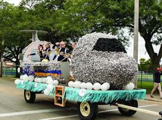 a parade float is decorated with balloons and streamers