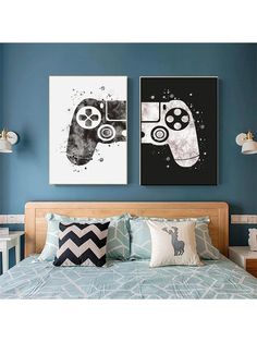 two black and white paintings on the wall above a bed in a room with blue walls