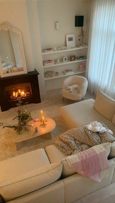 a living room filled with furniture and a fire place in the middle of the room