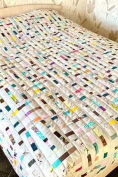 the bed is made up with many different colored squares