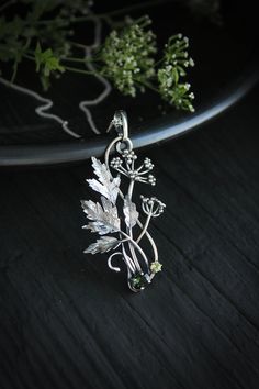 ITEM DESCRIPTION: The size H 5 cm x W 3 cm (2 x 1 1/3 inch). Weight - 5 g. You can buy it with a silver chain or without it. Even simple plants look very elegant. I made one of sterling silver, pretty green tourmaline, and peridot. This unique botanical jewelry looks like a real treasure of wild forest. It is really worthy of being in your precious collection. Expect many compliments on this! This handmade necklace will come to you in a gift box - ready for gifting. The parcel will be sent durin Silver Botanical Necklace With Round Pendant, Parsley Plant, Woodland Jewelry, Cow Parsley, Mushroom Jewelry, Plant Jewelry, Jewelry Looks, Metalsmithing Jewelry, Wild Forest