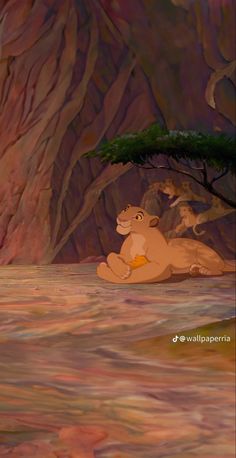 the lion king and cub are sitting under a tree in front of a mountain range