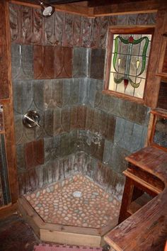 a bathroom that has a stone shower in it