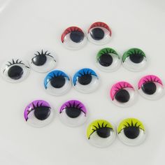 six pairs of fake eyeballs with different colors and designs on the outside of them