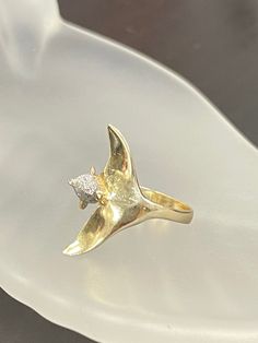 A beautiful and elegant ring of a dolphin wrapped around the finger. The dolphin has a sparkly white gold finish on its head, and the rest is high polish gold. It is 20mm wide, the span of the fins, and sits flat to the finger. Marked 14K, made in solid 14K gold, not plated. 2.7g Elegant Shell-shaped Gold Rings, Dolphin Ring Gold, Shell-shaped Yellow Gold Plated Jewelry, Luxury Yellow Gold Fish-shaped Necklace, Dolphin Jewelry, Small Crosses, Elegant Ring, Wrap Rings, Signet Ring