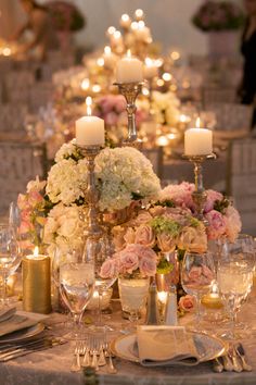 an elegant table setting with candles and flowers