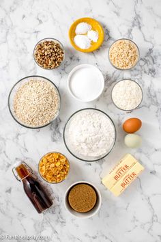 the ingredients for an oatmeal breakfast laid out on a marble counter top