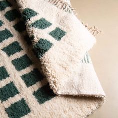 a white and green rug laying on top of a table