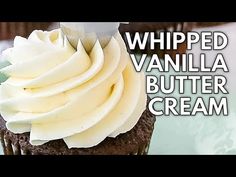 a chocolate cupcake with whipped vanilla butter cream on top and the words whipped vanilla butter cream over it