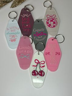 six different colored tags with bows and words on them are hanging from a string next to a pair of scissors