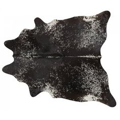 a black and white cowhide rug is shown on a white background with the reflection of it's skin