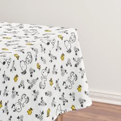 a white table cloth with winnie the pooh characters on it and yellow stars in the background