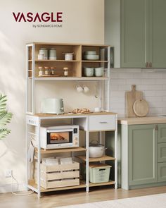 a white microwave oven sitting inside of a kitchen next to green cupboards and cabinets