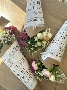 flowers are wrapped in brown paper and tied around them