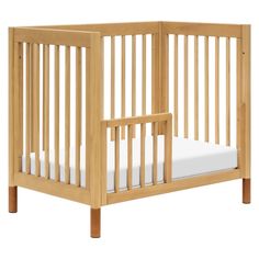 a small wooden crib with white sheets on the bottom and side rails, against a white background