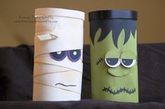 two paper cups that have faces and eyes on them