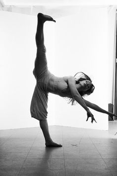 a woman is doing a handstand on the floor