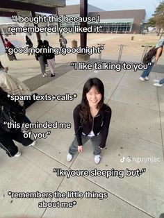 a woman sitting on the ground next to some stairs with words written in front of her