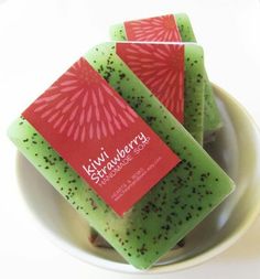 kiwi strawberry soaps in a bowl on a white tablecloth with a red and green label