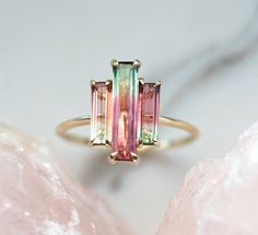 Three stone natural watermelon tourmaline ring. SOLD Similar can be made with other similar tourmalines. The design can be made with gemstones of your choosing. If you would prefer a custom ring, please contact us before purchase. Please take a look at our similar designs at the following links: https://www.etsy.com/listing/498675762/tourmaline-ring-diamond-engagement-ring https://www.etsy.com/listing/523459035/tourmaline-ring-diamond-engagement-ring Details; Main stone: bicolor watermelon tourm Watermelon Tourmaline Engagement Ring, Bijoux Art Deco, Pink Wedding Rings, Watermelon Tourmaline Ring, Baguette Engagement Ring, Tourmaline Engagement Ring, Ring Baguette, Ring Rosegold, Baguette Ring