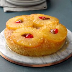 a pineapple upside down cake on a marble plate