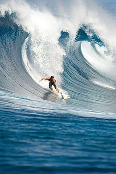 a man riding a wave on top of a surfboard