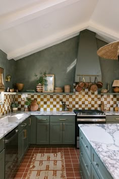 a kitchen with green cabinets and checkered backsplashes on the counter tops