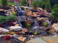 a small waterfall in the middle of a garden