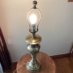 an old fashioned lamp on a wooden table