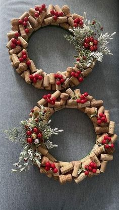 two wreaths made out of wine corks and berries