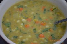 a bowl of soup with carrots, celery and corn on the side