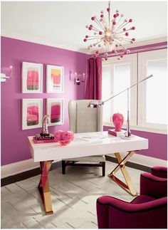 a living room with purple walls and furniture in the center, along with pictures on the wall