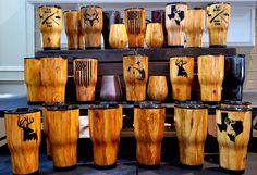 there are many wooden cups on display