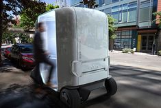 an electric vehicle is parked on the side of the road in front of a building