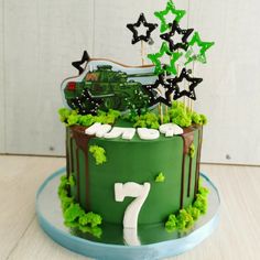 a birthday cake with green frosting and decorations