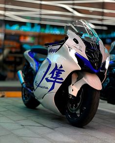 a white and blue motorcycle parked in front of a building