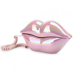 a shiny pink lip shaped object with a cord attached to the end of it's mouth