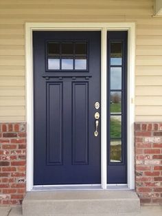 a blue front door on a brick house