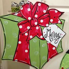 a decorated door hanger with a red bow and merry message