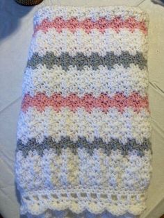 a crocheted blanket sitting on top of a table