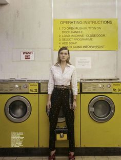 a woman is standing in front of washers