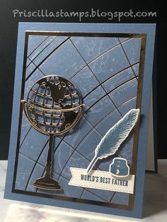 a card with a globe on it and a feather resting on top of the card