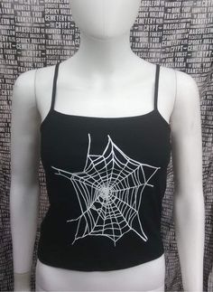 This is a black sleeveless Spiderwebs cropped tank top. This has a Spiderweb image screen printed on the front. 57% cotton/ 38% polyester/ 5% Spandex These are handmade screenprinted and slightly vary from the photo. Please feel free to email me any questions. Thanks for looking. Due to an influx of incorrect addresses if a package is returned, you must pay the shipping cost to resend the item to you. I do not do exchanges and I do not take returns unless the item is damaged. I thoroughly check Black Stretch Crop Top For Halloween, Edgy Black Crop Top For Halloween, Black Grunge Style Tank Top, Halloween Punk Black Crop Top, Black Halloween Crop Top For Streetwear, Black Punk Crop Top For Halloween, Black Rave Top For Halloween, Black Stretch Tank Top For Halloween, Gothic Black Crop Top