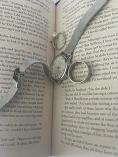 an open book with two watches on it