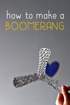 a person holding up a piece of paper with the words how to make a boomerang on it