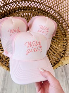 These trucker hats are our new favorites, and they will be yours too! Each style of hat has an adjustable band. Wear them with your hair down or up, and it will instantly make any outfit complete. This hat is pink with, "Wild Girl" printed in darker pink, colored text. Pink 5-panel Trucker Hat For Spring, Cute Pink Baseball Cap For Summer, Cute Summer Hats With Curved Bill, Pink Curved Bill Hats For Summer, Cute Pink Summer Baseball Cap, Adjustable 5-panel Snapback Hat, Pink Trucker Snapback Hat For Spring, Playful Pink Adjustable Baseball Cap, Playful Adjustable Pink Baseball Cap