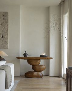 a living room with a couch, coffee table and candles on the tables in it